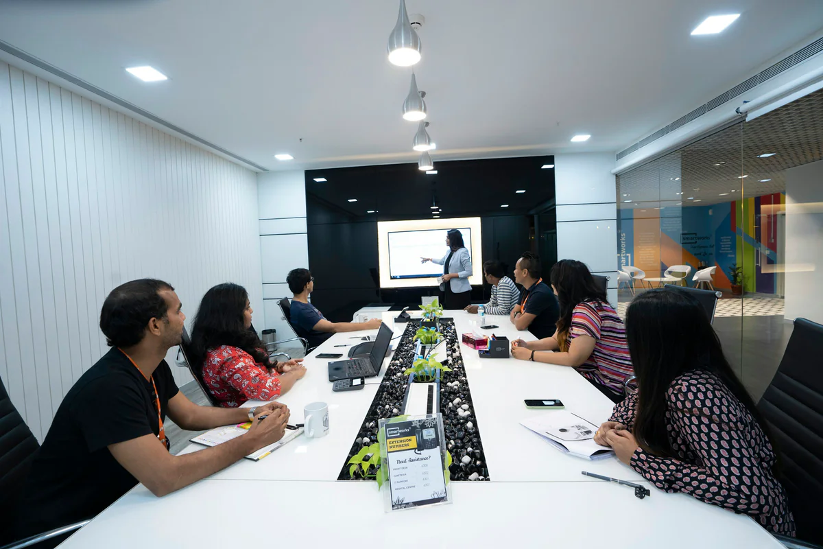 A presenter speaking to a group in a meeting room