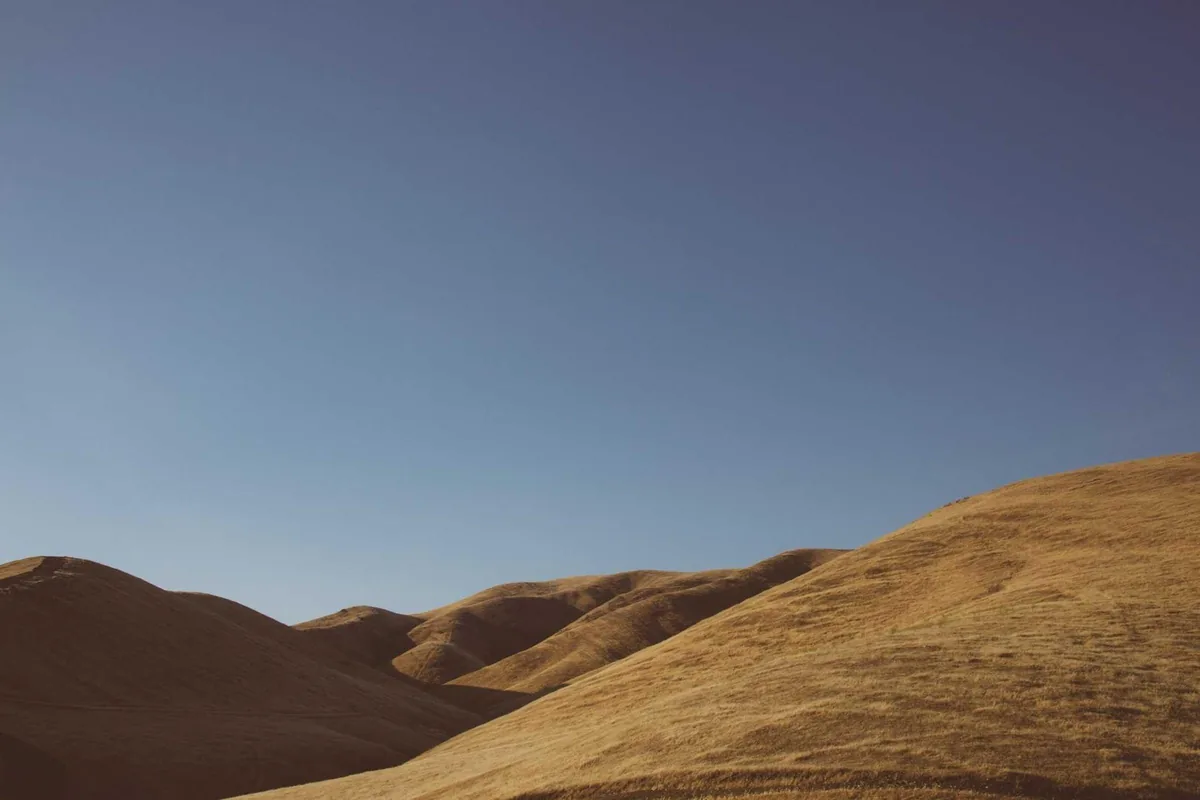 A road climbing uphill through open country