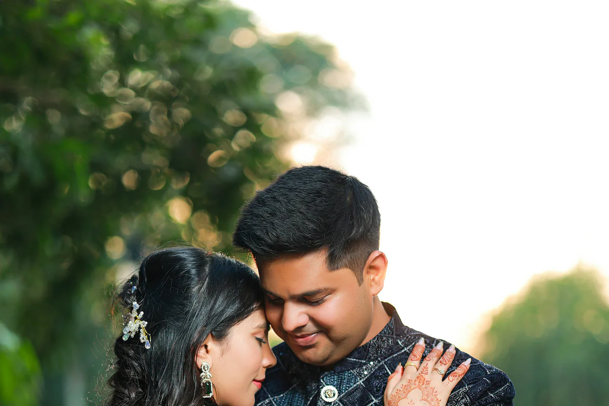Two people in Indian attire embracing outdoors