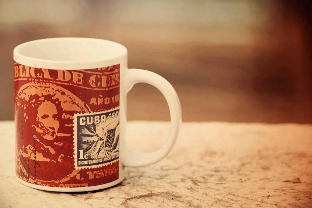 A red-patterned coffee mug on a wooden table