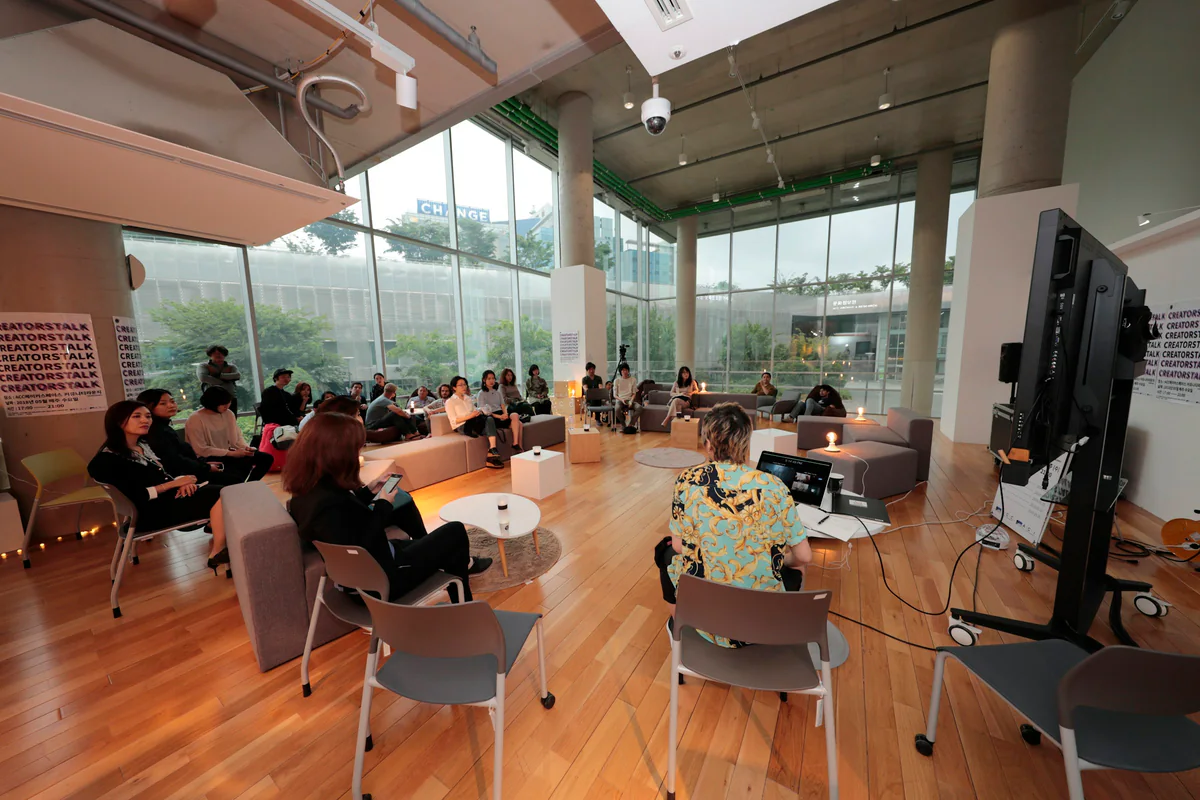 People seated during a presentation in a bright room